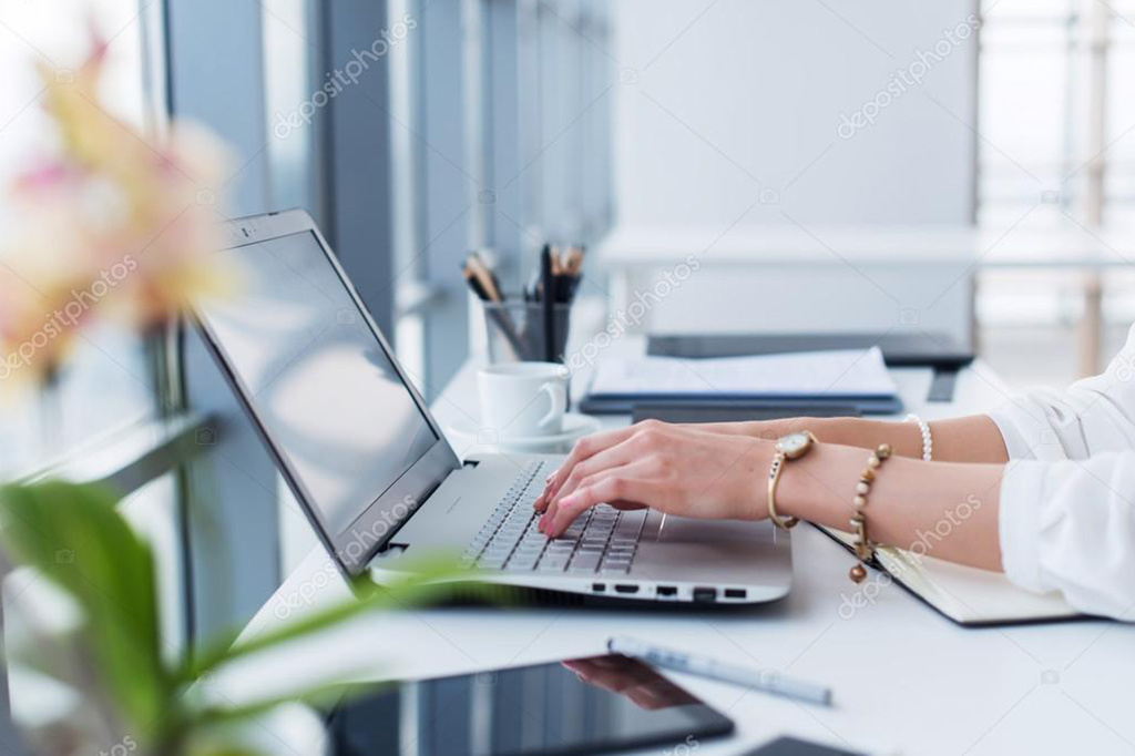 Woman Typing in a Laptop